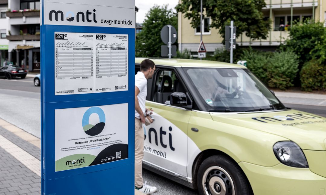 Ein Bild zeigt einen Mann, der am Wiehler Busbahnhof ein On-demand-Angebot nutzt.